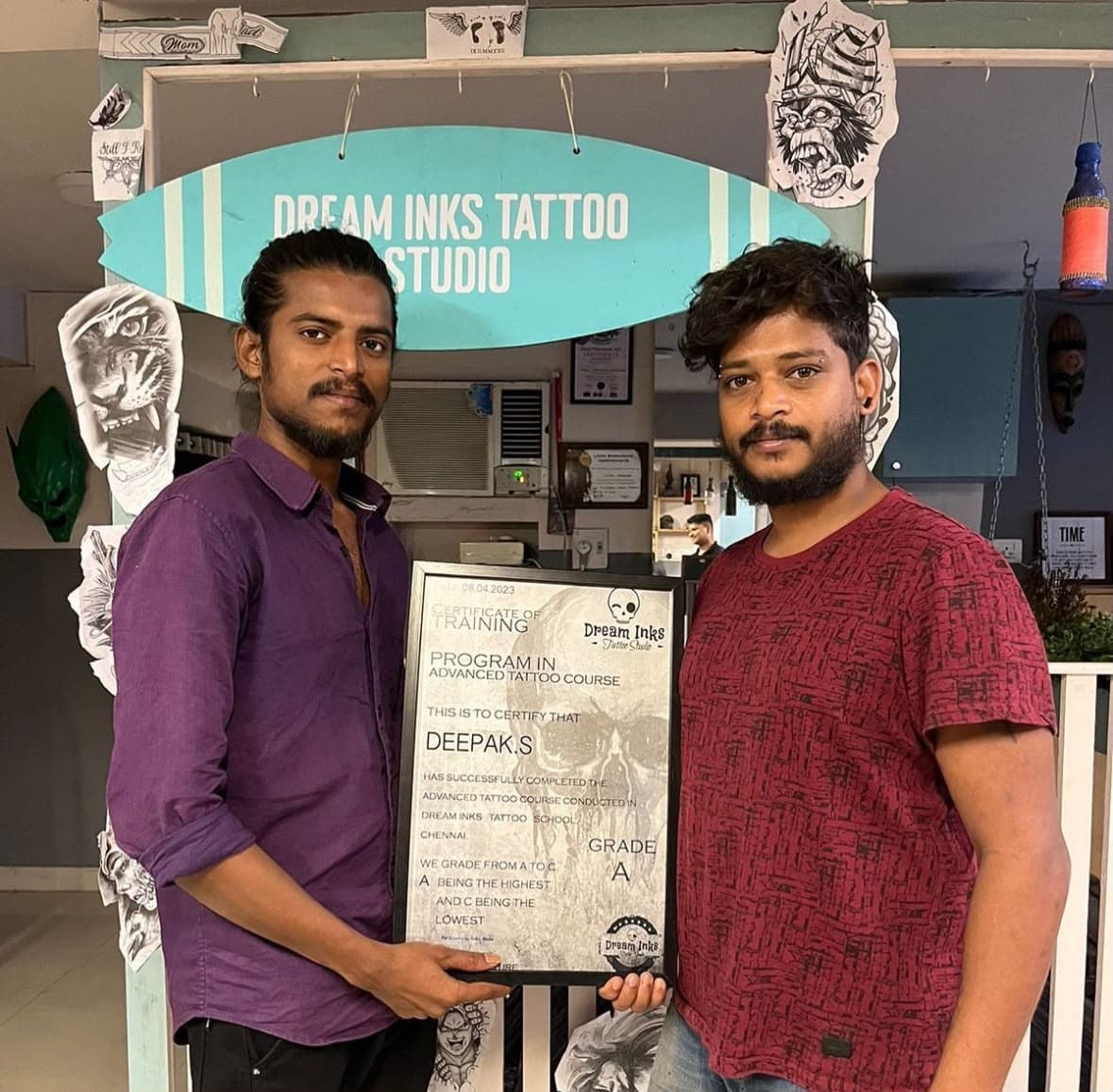 Deepak S at Dream Inks studio with his advanced tattoo course certificate